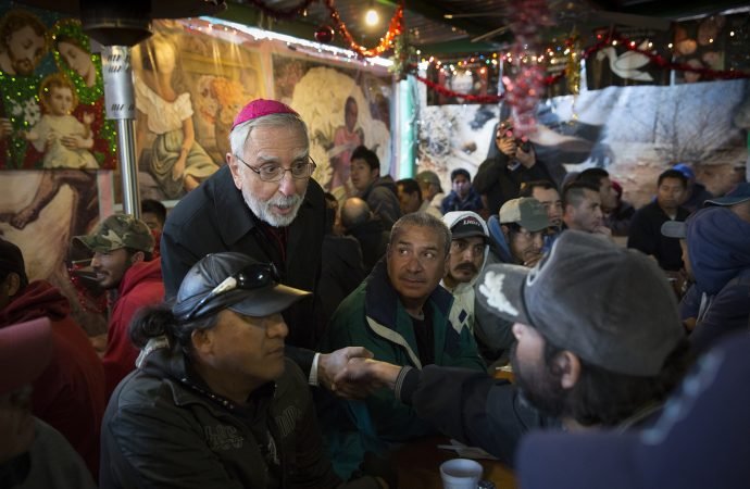 Bishop Gerald F. Kicanas of Tucson greets men at the "comedor