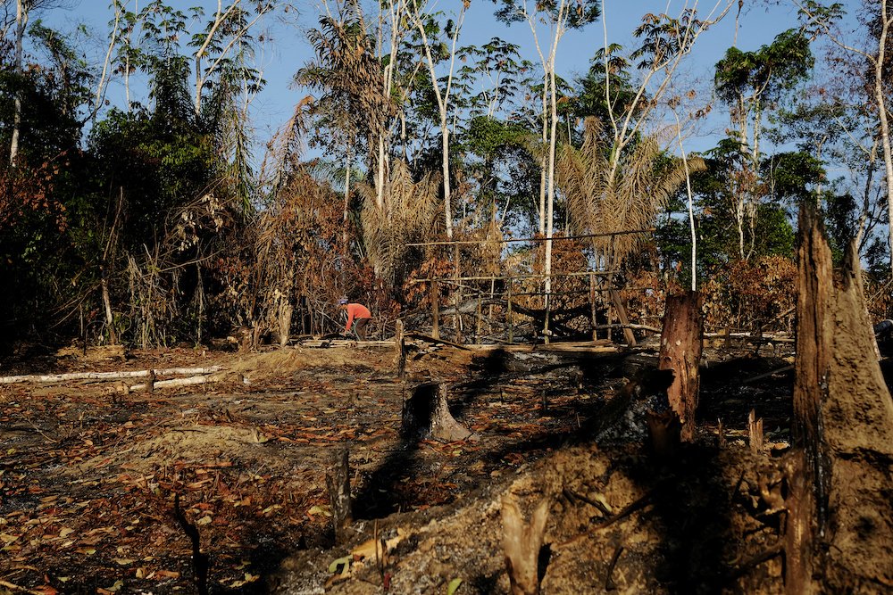 A wildcat gold miner builds his makeshift home at a deforested area of the Amazon rainforest near Crepurizao