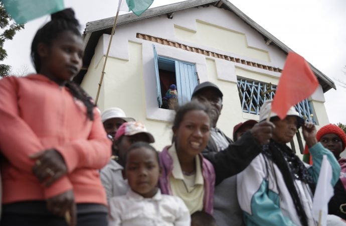 People wait for the arrival of Pope Francis on the occasion of his visit to the City of Friendship in Akamasoa