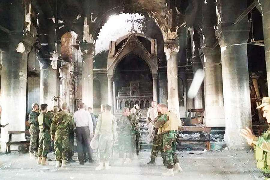 Pershmerga fighters inspect Al Tamera Syriac Catholic parish in Qaraqosh