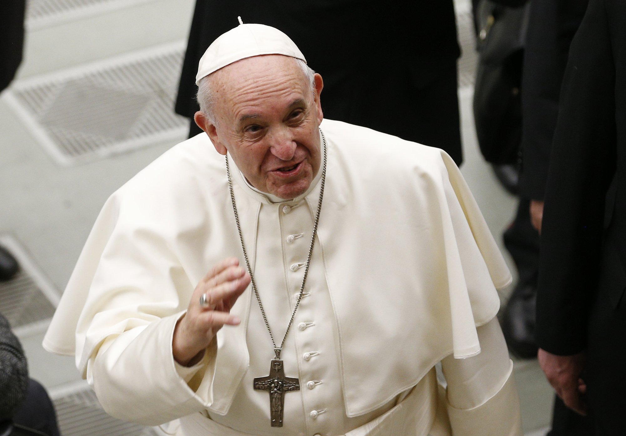 Pope Francis waves to journalists during his general audience in Paul VI hall at the Vatican Feb. 20