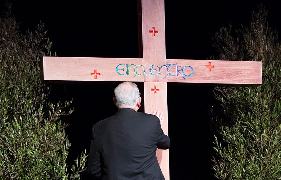 Archbishop José H. Gomez of Los Angeles prays in front of a cross Jan. 27 during a gathering of more than 1