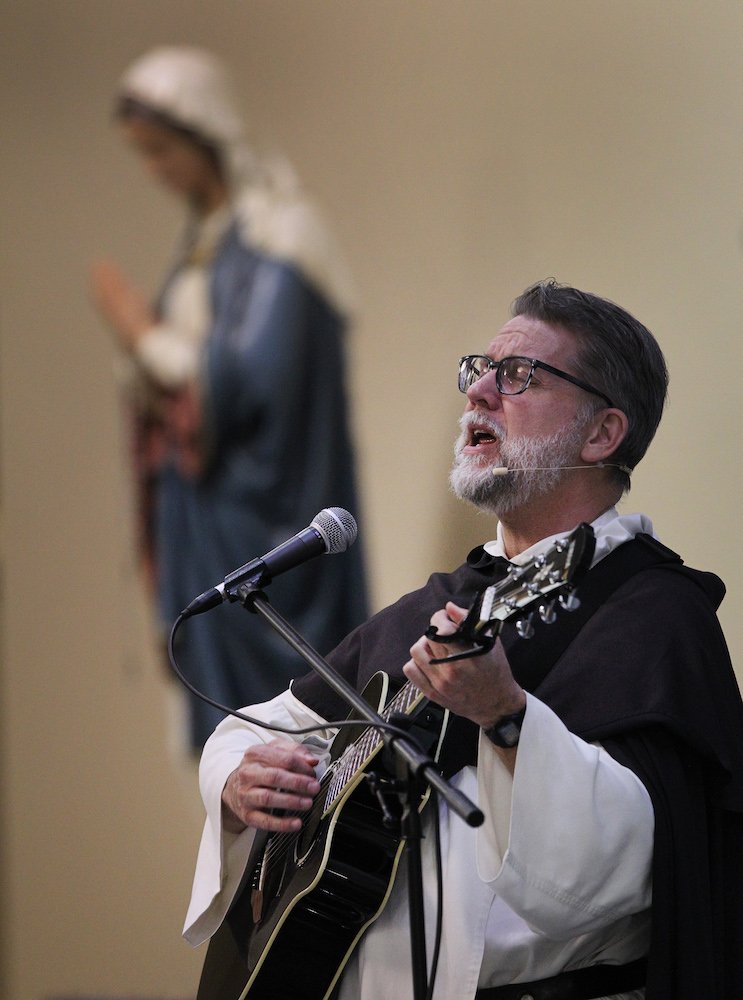 Dominican Father Bill Garrott sings as he leads a parish mission at Jesus the Divine Word Church in Huntingtown