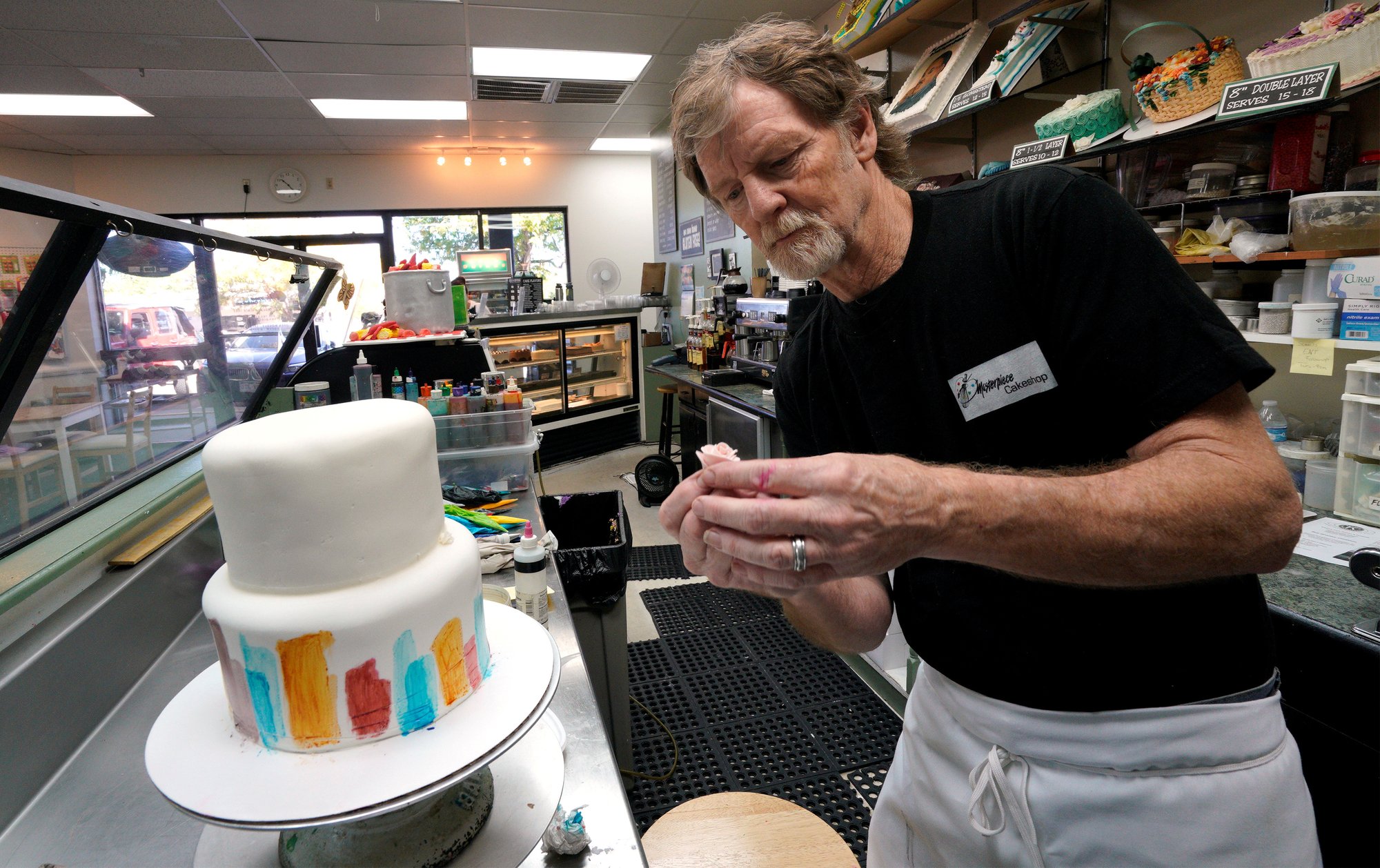 Baker Jack Phillips decorates a cake in his Masterpiece Cakeshop in Lakewood