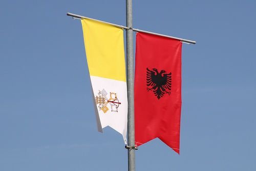 The flags of Albania and Vatican City in Tirana
