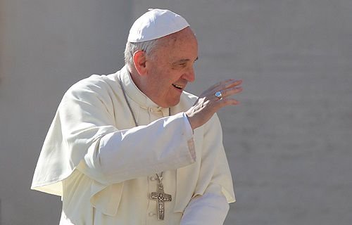 Pope Francis greets pilgrims in St. Peter's Square before the Wednesday general audience October 30