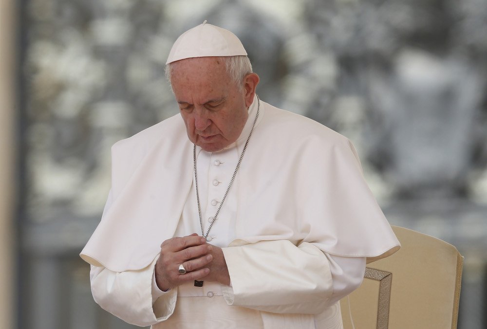 Pope Francis prays during his general audience in St. Peter's Square at the Vatican May 22
