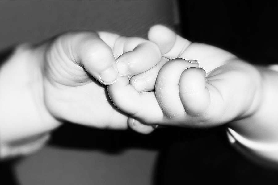 Babies holding hands. Credit: nicoleverschoor via Flickr (CC BY NC ND 2.0)