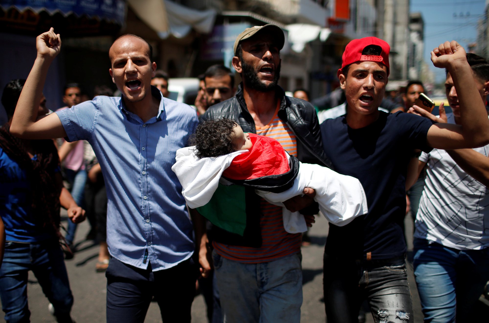 Mourners carry the body of 8-month-old Palestinian Laila al-Ghandour