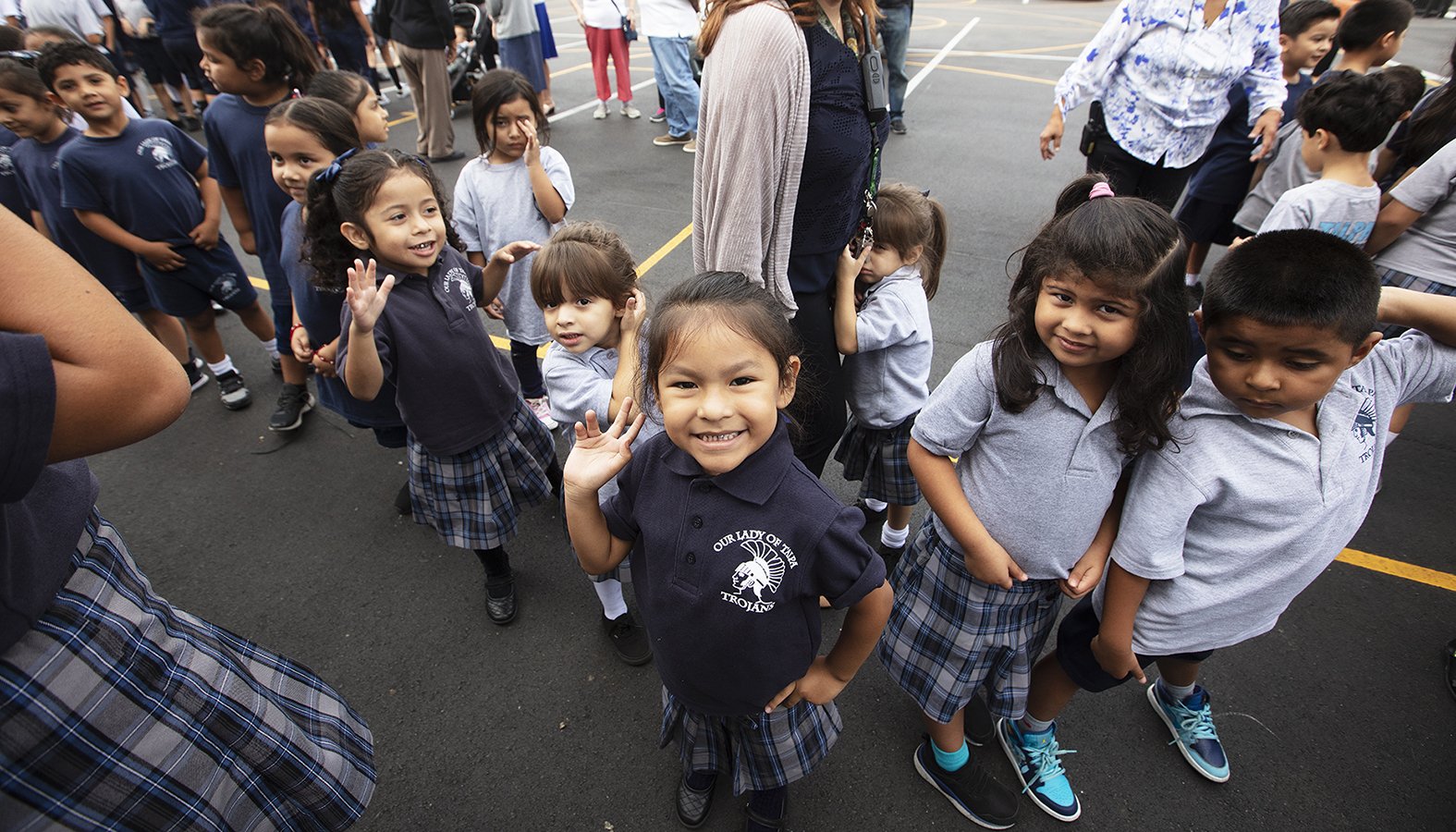 Students wait outside to see the newly renovated Our Lady of Talpa school gymnasium. (Victor Alemán)