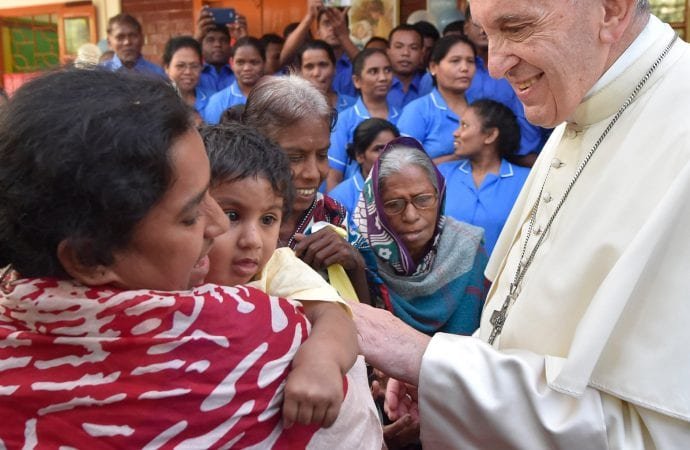 Pope Francis greets a child during a visit at the Mother Teresa House in the Dhaka's Tejgaon neighborhood