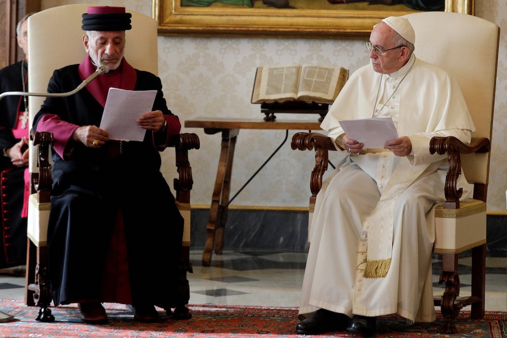 Pope Francis listens to a speech from Catholicos Gewargis III