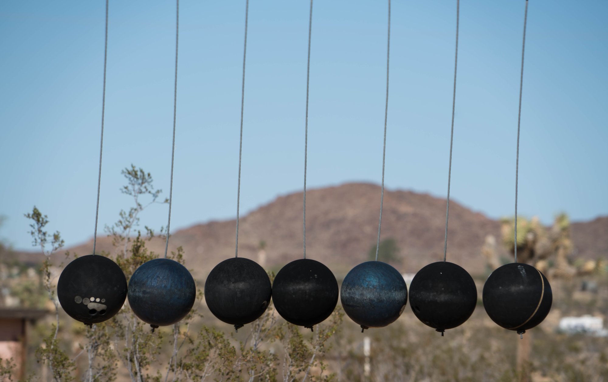 Noah Purifoy's seven suspended bowling balls. (CHRIS GOLDBERG/FLICKR)