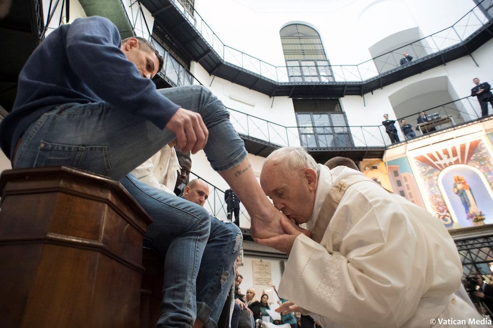 Pope Francis kisses the foot of an inmate during Holy Thursday Mass at Regina Coeli prison in Rome in this March 29