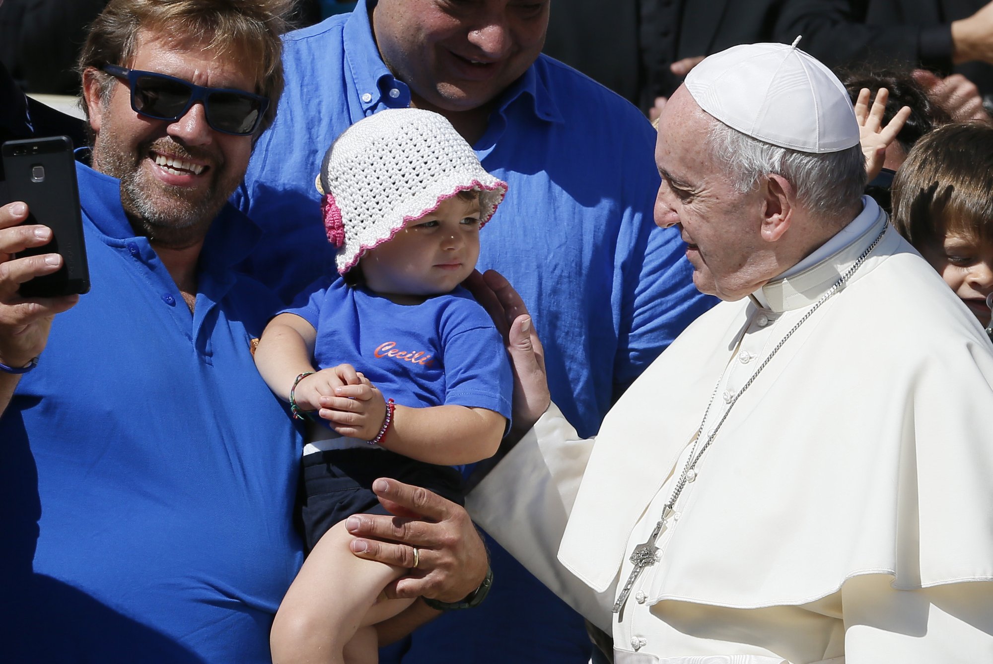 Pope Francis greets a young child during his general audience in St. Peter's Square at the Vatican Sept. 12. (CNS photo/Paul Haring)