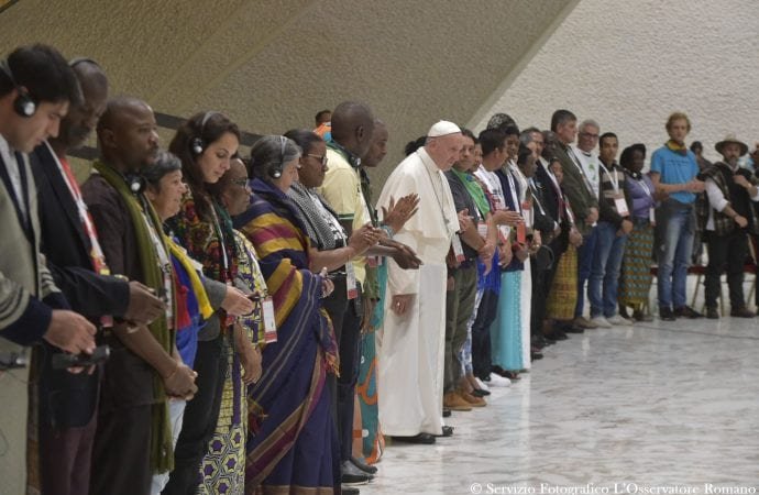 Pope Francis stands during an audience with representatives of the popular movements at the Vatican Saturday