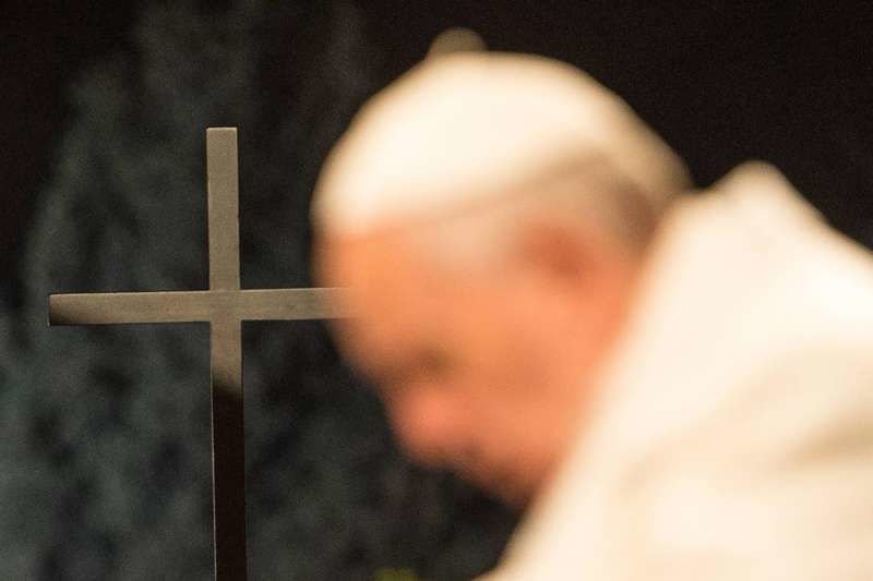 Pope Francis and a cross during the Stations of the Cross at the Coliseum in Rome