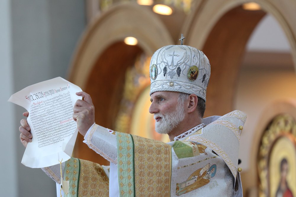Metropolitan-Archbishop Borys Gudziak displays the papal bull about his appointment during his enthronement as head of the Ukrainian Catholic Archeparchy of Philadelphia at the Ukrainian Catholic Cathedral of the Immaculate Conception June 4