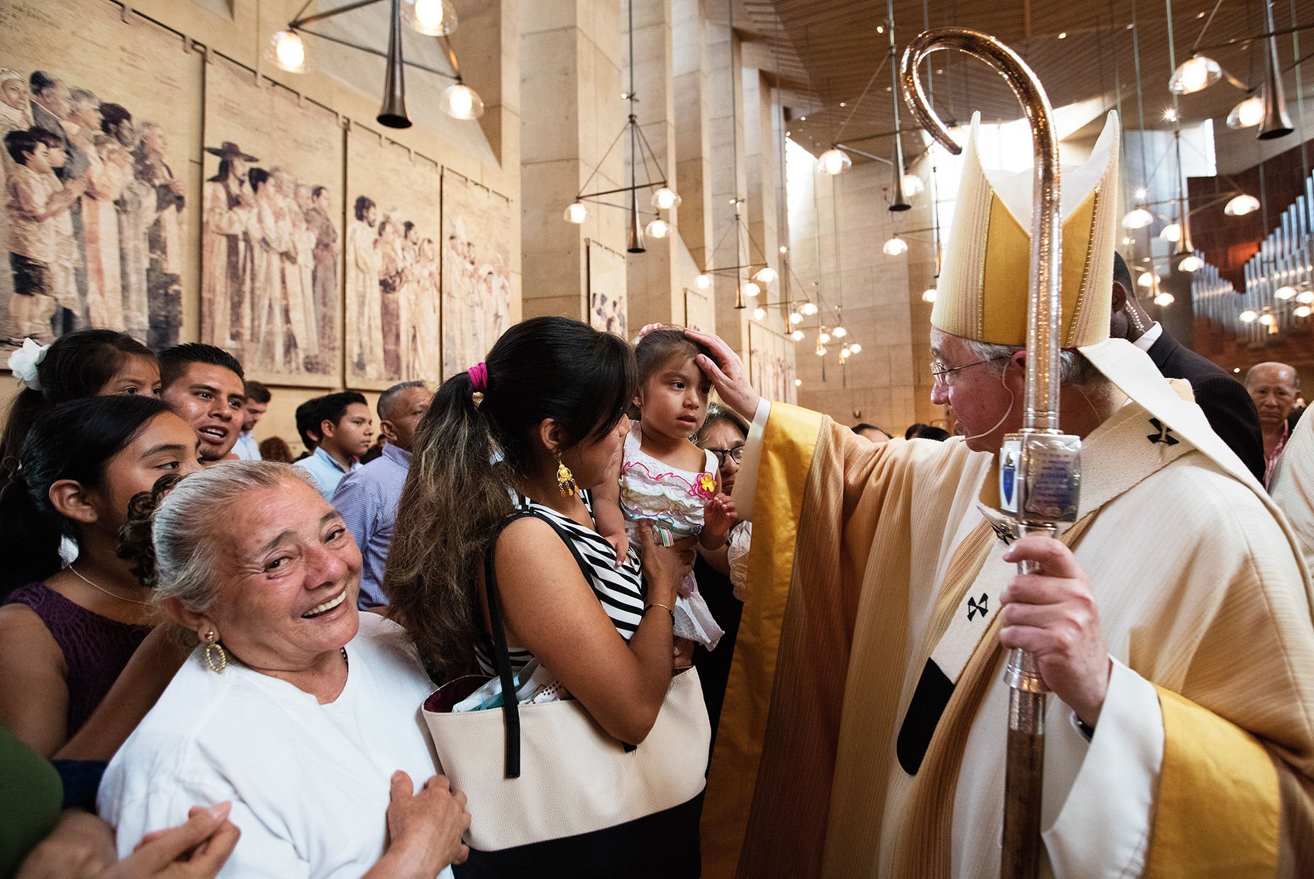 Archbishop Jose H. Gomez blesses a girl during the 2016 Mass in Recognition of All Immigrants at the Cathedral of Our Lady of the Angels in Downtown Los Angeles. (Photo/Victor Aleman)