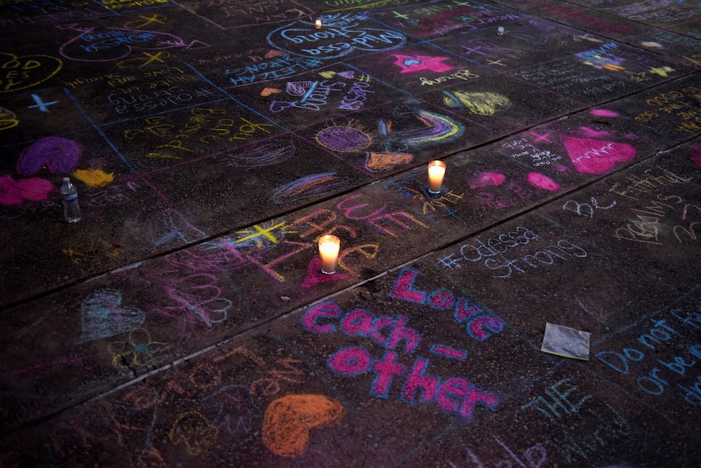 Messages written in sidewalk chalk are seen as people gather for a Sept. 1
