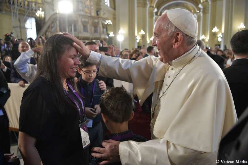 Pope Francis blesses a woman after venerating the relics of Peruvian saints in the Cathedral of Lima