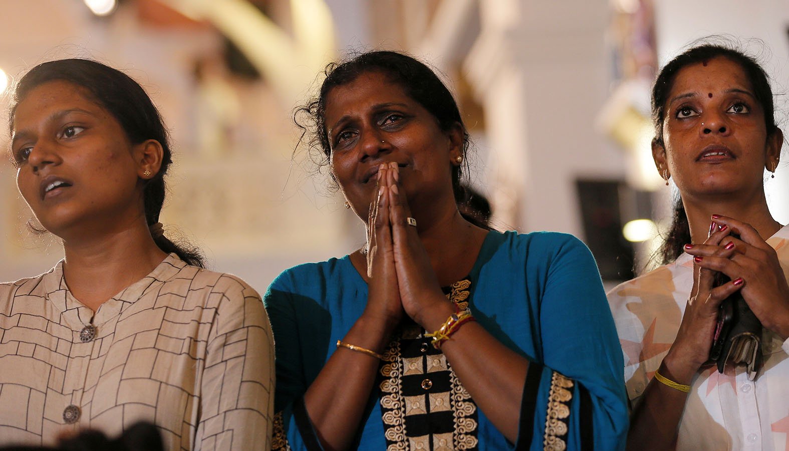 Family members of victims react while praying during the reopening ceremony of St. Anthony's Shrine in Colombo, Sri Lanka, June 12, 2019, months after it was closed because of an Easter bombing. (CNS photo/Dinuka Liyanawatte, Reuters)