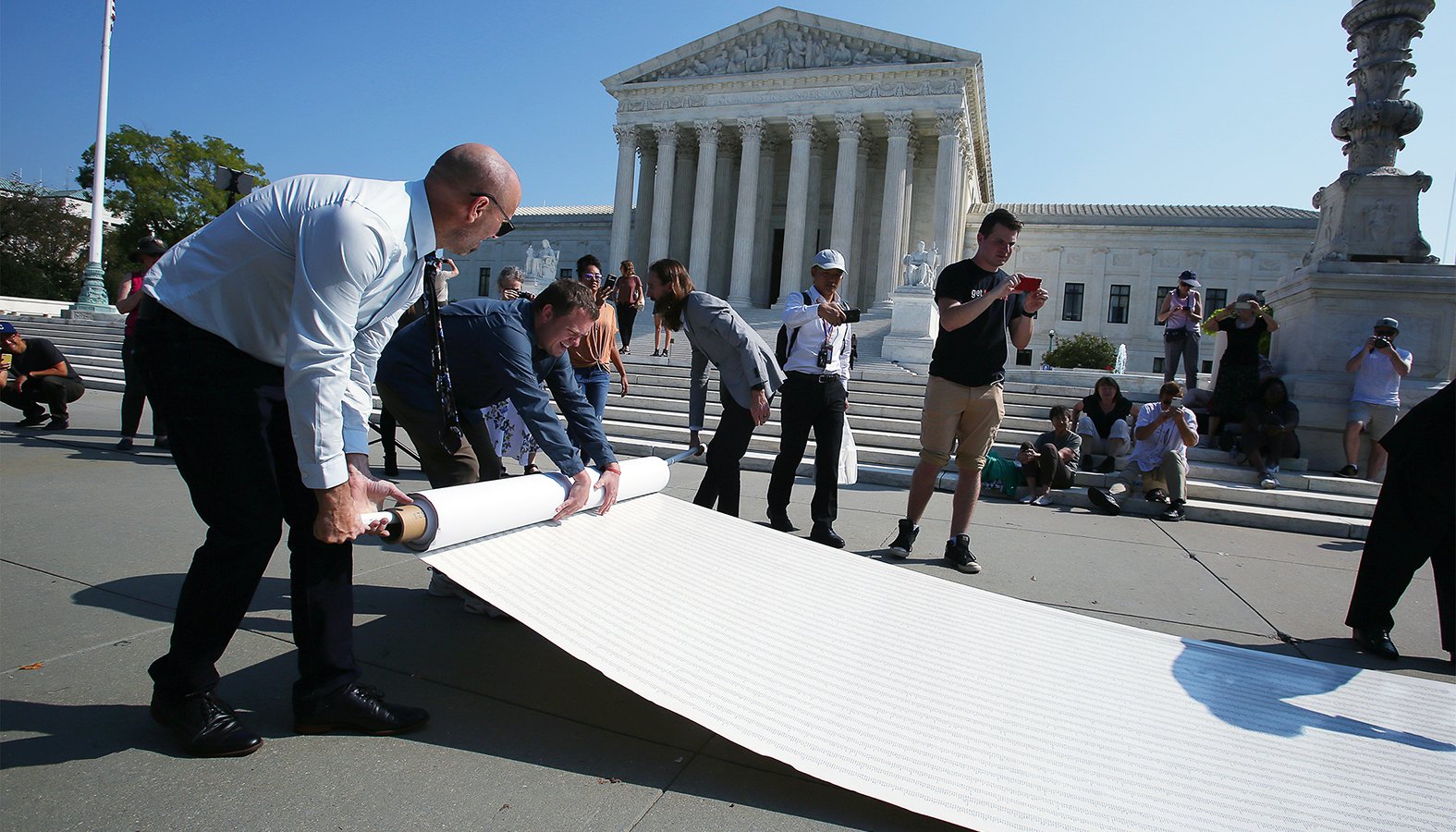 Pro-life leaders unfurl a petition in front of the U.S. Supreme Court in Washington Oct. 1, 2019, with more than 250,000 signatures calling for the court to overturn Roe v. Wade. (CNS photo/Tyler Orsburn)