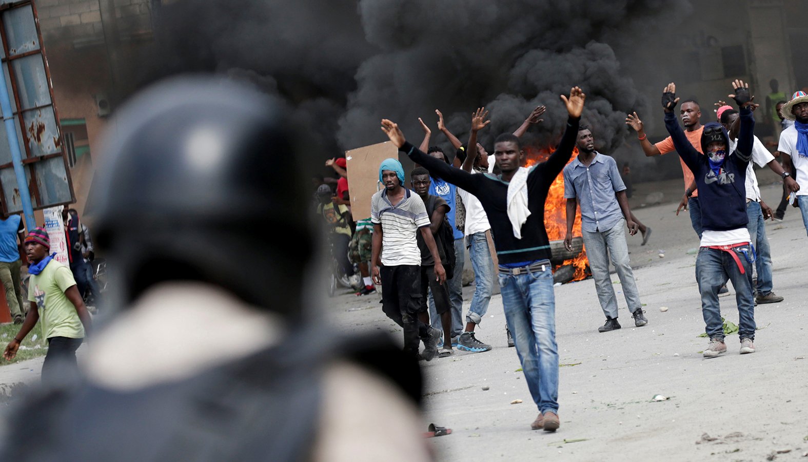 Protesters in Port-au-Prince, Haiti, clash with security forces Oct. 4, 2019, during a demonstration to demand the resignation of President Jovenel Moise. As Port-au-Prince began its fourth week of paralysis due to serious social unrest, the Haitian bishops' justice and peace commission called on Moise to step down. (CNS photo/Andres Martinez Casares, Reuters)