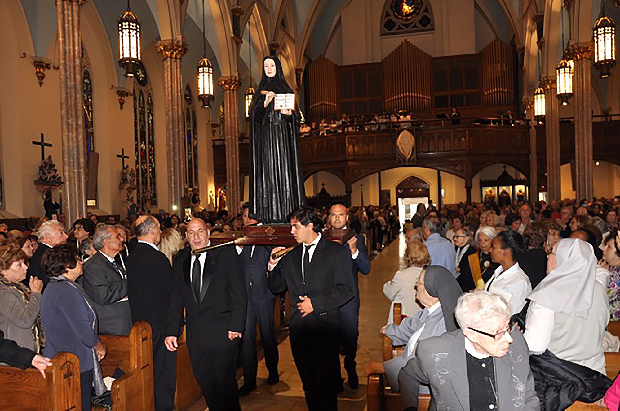 A statue of St. Frances Xavier Cabrini, who is the patroness of immigrants and once lived in Brooklyn, N.Y., is carried into Sacred Hearts-St. Stephen Church in Brooklyn Oct. 6, 2019. Calls for a statue of Mother Cabrini, as she is best known, began as part of the She Built NYC project, a public arts initiative that aims to increase the number of statues of women in New York City. (CNS photo/Ed Wilkson, The Tablet)