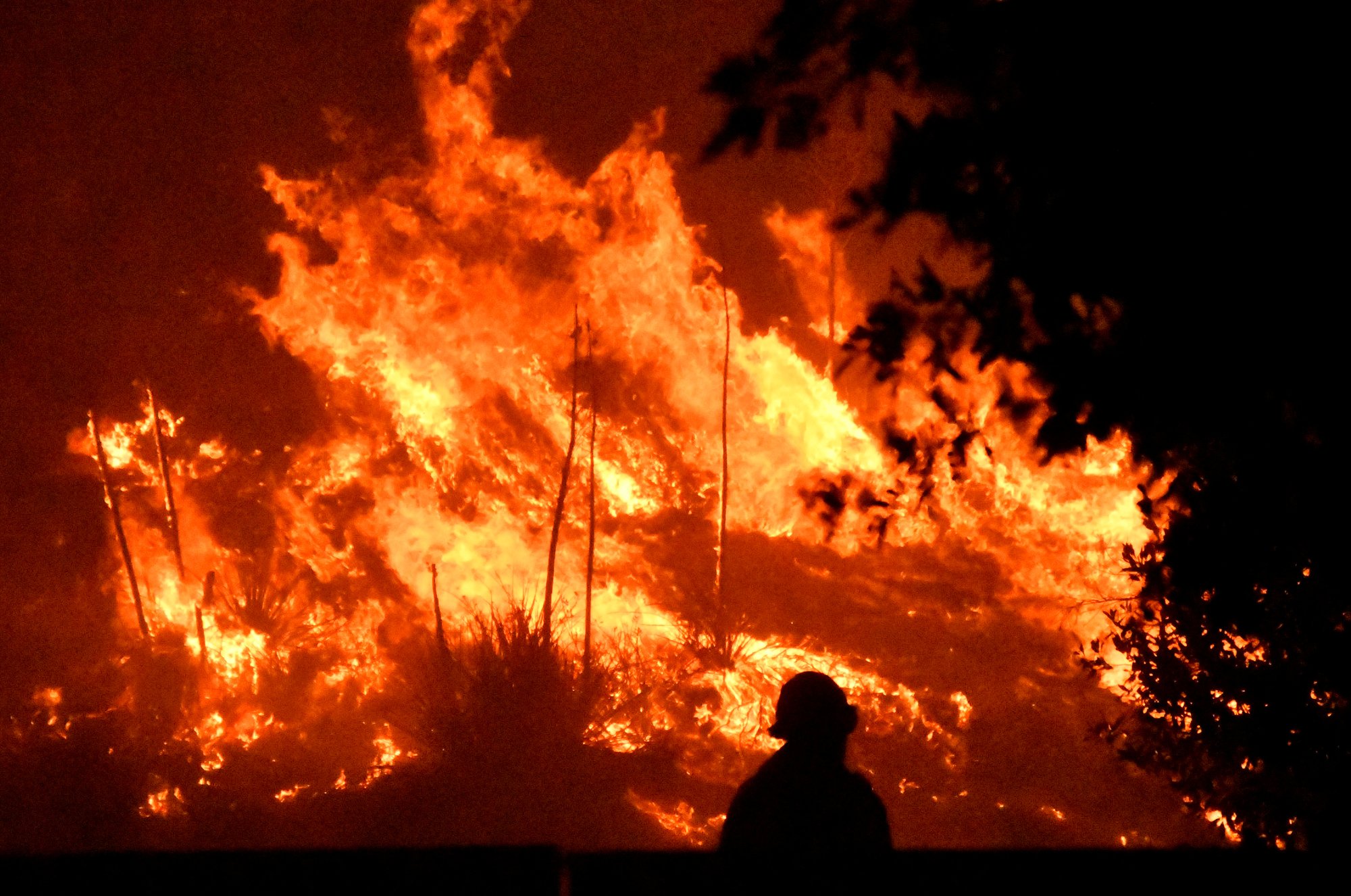 A firefighter is seen near a wind-driven wildfire burns Oct. 11, 2019, in Porter Ranch, Calif. The Archdiocese of Los Angeles is providing support to the communities affected by the fires through Catholic Charities of Los Angeles and local parishes and schools. (CNS photo/Gene Blevins, Reuters)