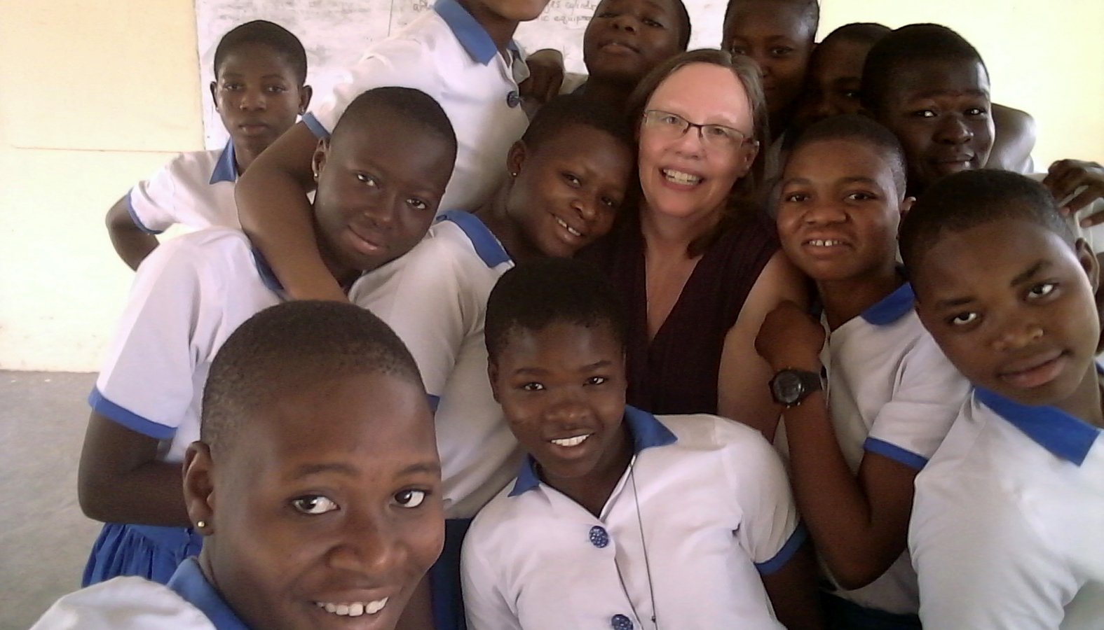 Diane Yonga, a Catholic from St. Paul, Minn., poses for a photo Feb. 7, 2019, with students at St. Anne's Girls Senior High School in Damongo, Ghana. Her calling to be a missionary is being fulfilled through the Lay Mission-Helpers Association in Los Angeles and the Center for Mission in the Archdiocese of St. Paul and Minneapolis. (CNS photo/Diane Yonga, courtesy The Catholic Spirit)
