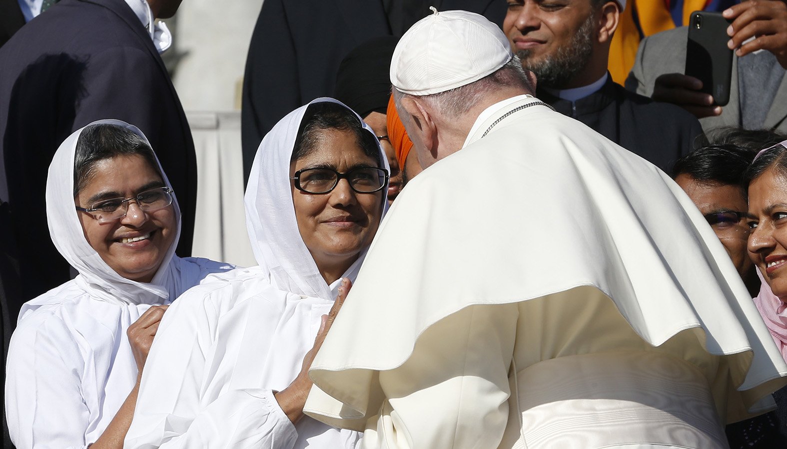 Pope Francis greets people during his general audience in St. Peter's Square at the Vatican Oct. 23, 2019. The pope greeted people taking part in an interreligious conference promoted by the Sikhi Sewa Society. (CNS photo/Paul Haring)