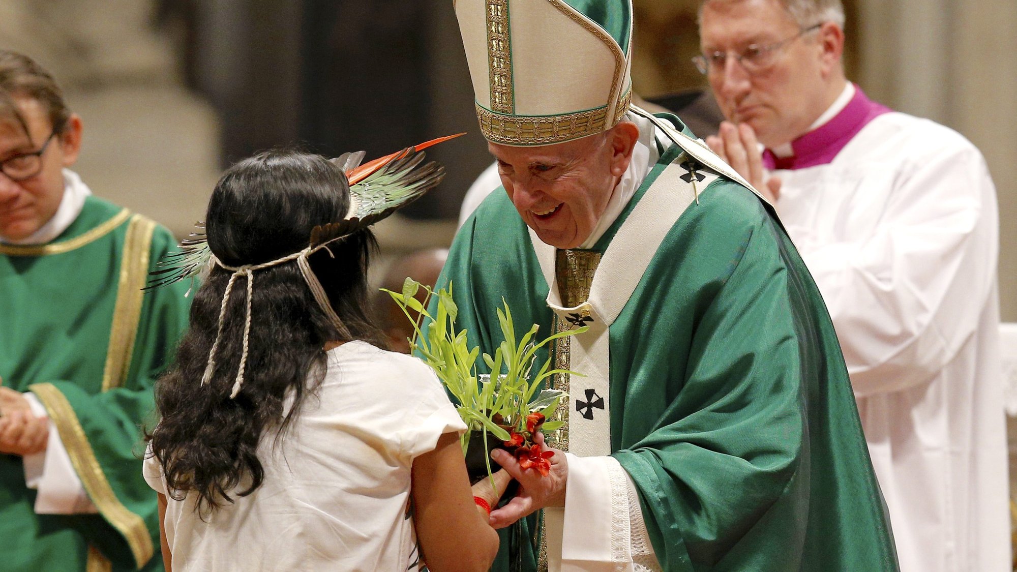 Pope Francis accepts a plant during the offertory as he celebrates the concluding Mass of the Synod of Bishops for the Amazon at the Vatican Oct. 27, 2019. (CNS photo/Paul Haring)