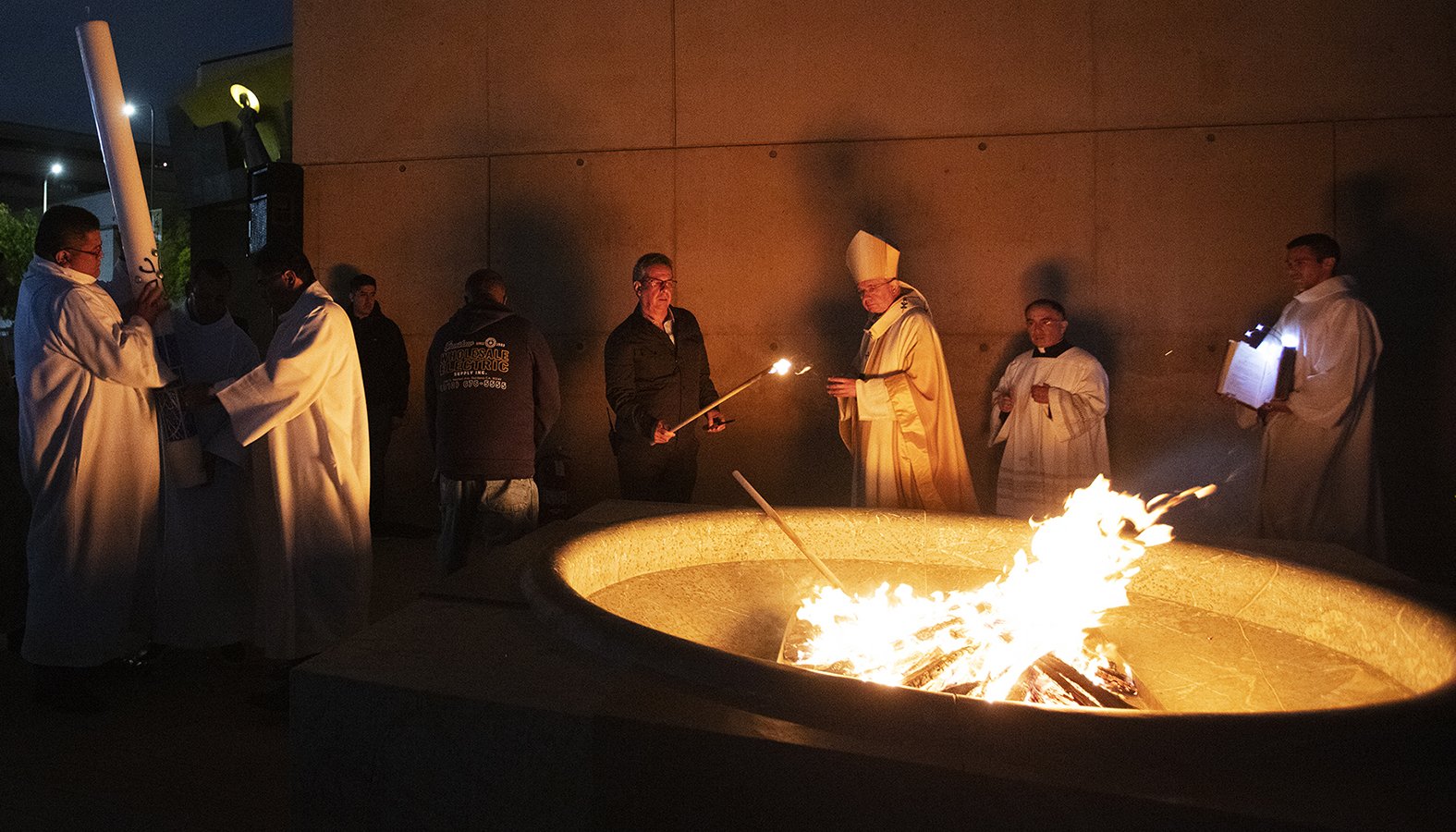Archbishop José H. Gomez prepares to light the paschal candle after blessing the fire outside the Cathedral of Our Lady of the Angels during the Easter Vigil celebration April 20, 2019. (Victor Alemán/Angelus News)