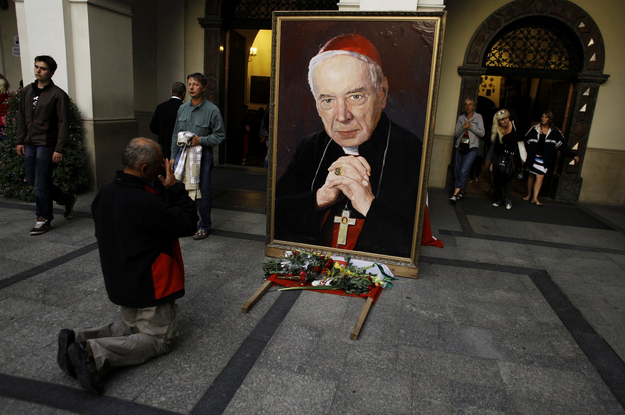 A man prays in front of a portrait of Polish Cardinal Stefan Wyszynski Aug. 14, 2012, at Jasna Gora Monastery in Czestochowa. Pope Francis recognized the miracle needed for the beatification of Cardinal Wyszynski, a mentor and friend of St. John Paul II. (CNS photo/Kacper Pempel, Reuters)
