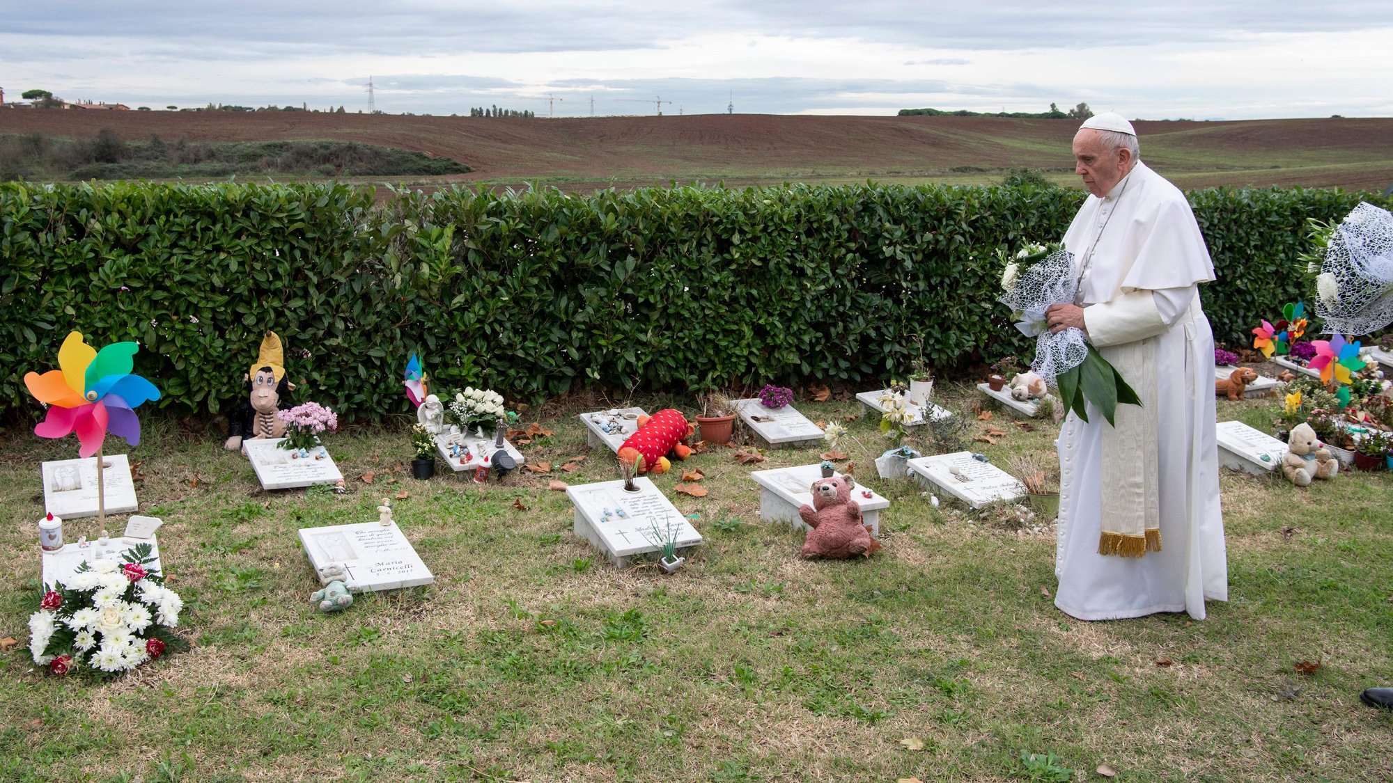 Pope Francis visits graves of children before celebrating Mass marking the feast of All Souls at Laurentino Cemetery in Rome Nov. 2, 2018. (CNS photo/Vatican Media)
