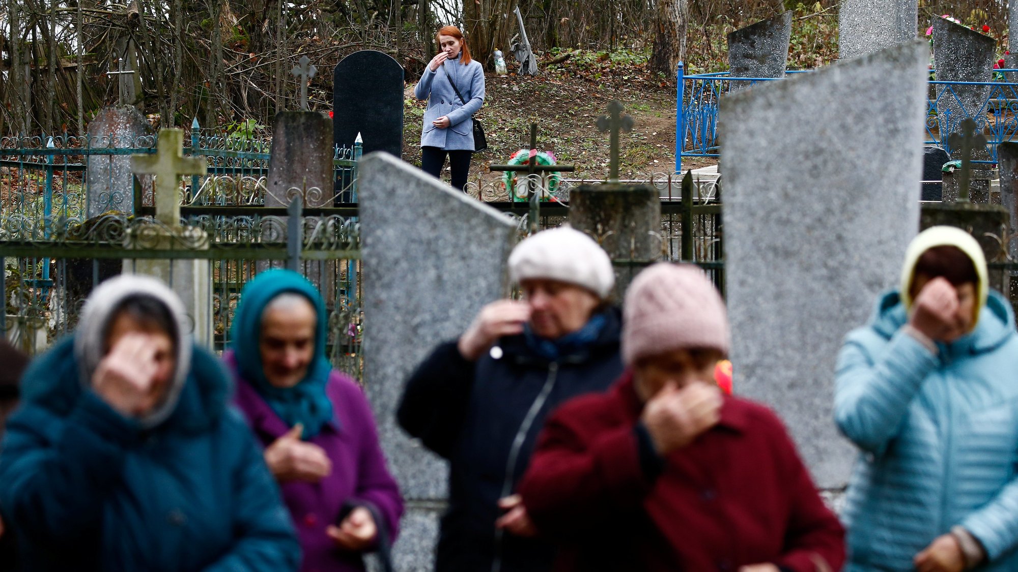 People in Starayelnya, Belarus, visit graves during All Saints Day Nov. 1, 2019. In a video message to young people participating in the World Youth Encounter in Mexico City, Pope Francis said death teaches people to "relate with mystery" and to trust that there is something beyond death. (CNS photo/Vasily Fedosenko, Reuters)