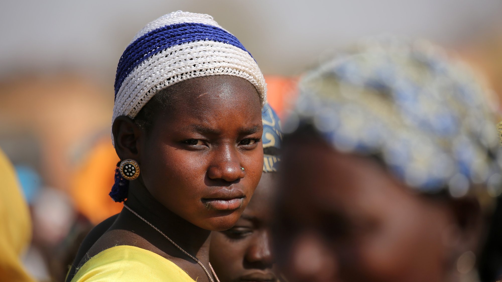 A displaced woman in Dablo, Burkina Faso, looks on while she waits for help March 1, 2019. (CNS photo/Luc Gnago, Reuters)