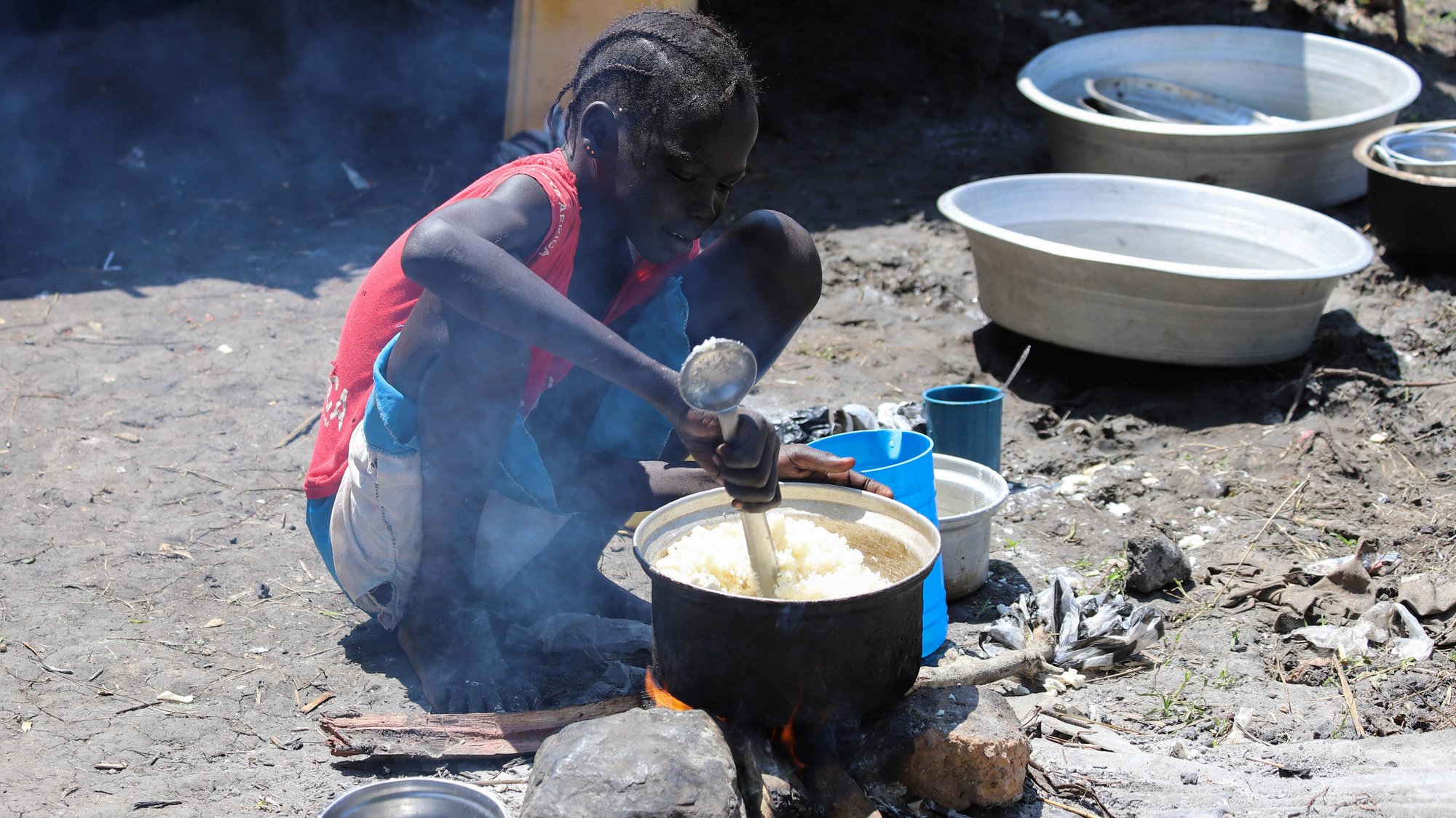 A child prepares a meal outside a makeshift shelter Nov. 1, 2019, in Gumuruk, South Sudan. A negligent and selfish culture of food waste is fueling the global hunger crisis, damaging the lives of individuals, and preventing the progress of all people, Pope Francis said Nov 18. (CNS photo/Samir Bol, Reuters)