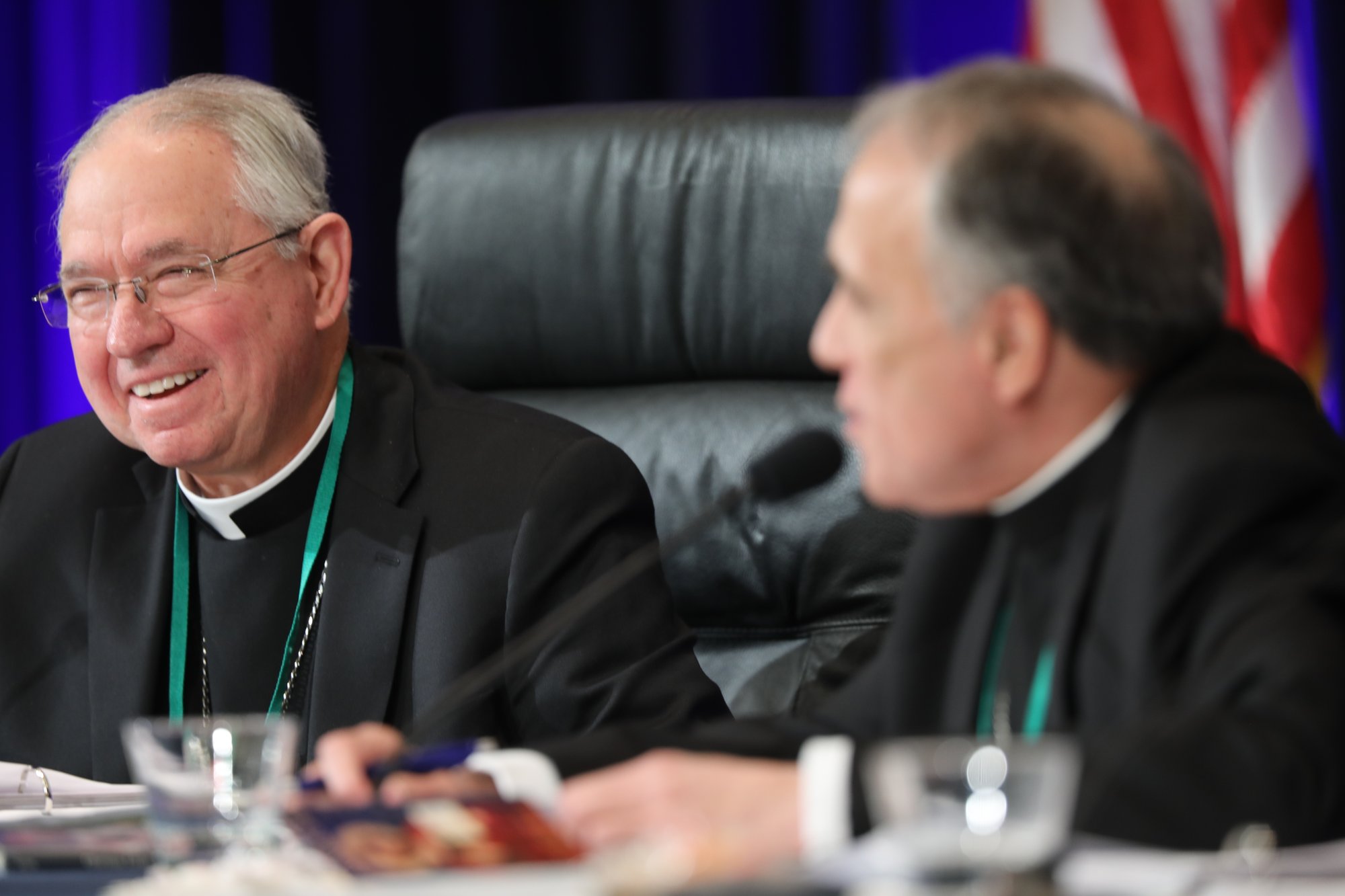 Archbishop José H. Gomez of Los Angeles, president-elect of the U.S. Conference of Catholic Bishops, and outgoing president, Cardinal Daniel N. DiNardo of Galveston-Houston, smile during the fall general assembly of the USCCB in Baltimore Nov. 13. (Bob Roller/Catholic News Service)