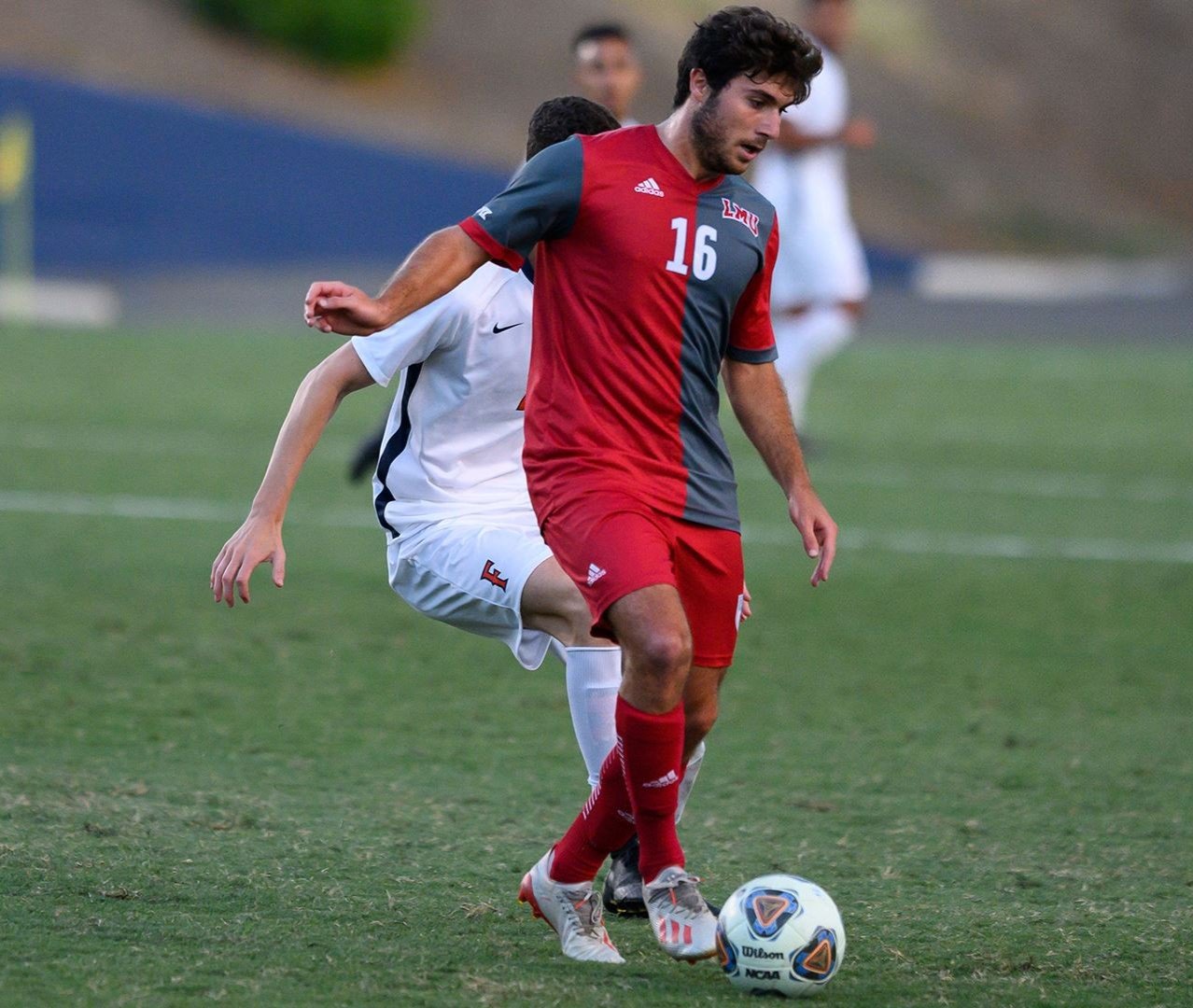 LMU’s Leo Zulli keeps the ball away from an attacker during a recent match. The Lions end their regular season this week in San Francisco. (LMU Athletics)