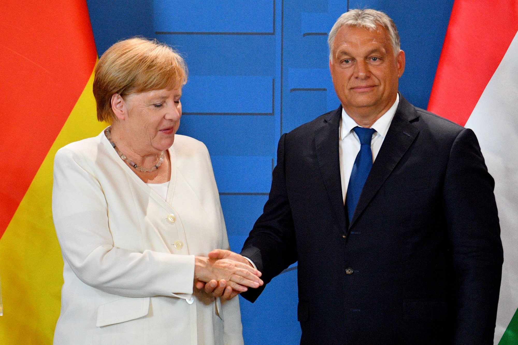 German chancellor Angela Merkel and Hungarian Prime Minister Viktor Orban shake hands following an August meeting in the Hungarian-Austrian border town of Sopron. Merkel and Orban are widely seen as representative of the opposing liberal and nationalist (respectively) policies in today's Europe. (Attila Kisbendek/AFP via Getty Images)