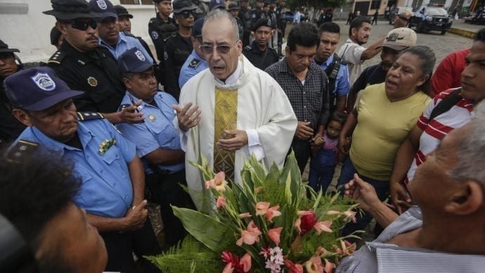 Father Edwin Roman attempts to convince the police to allow relatives of imprisoned and dead anti-government demonstrators to enter the San Miguel Arcangel Church in Masaya, Nicaragua, Thursday, Nov. 14, 2019. The relatives have started a hunger strike to demand the freedom of their relatives, jailed for protesting against the government of President Daniel Ortega. (AP Photo/Alfredo Zuniga via Crux)