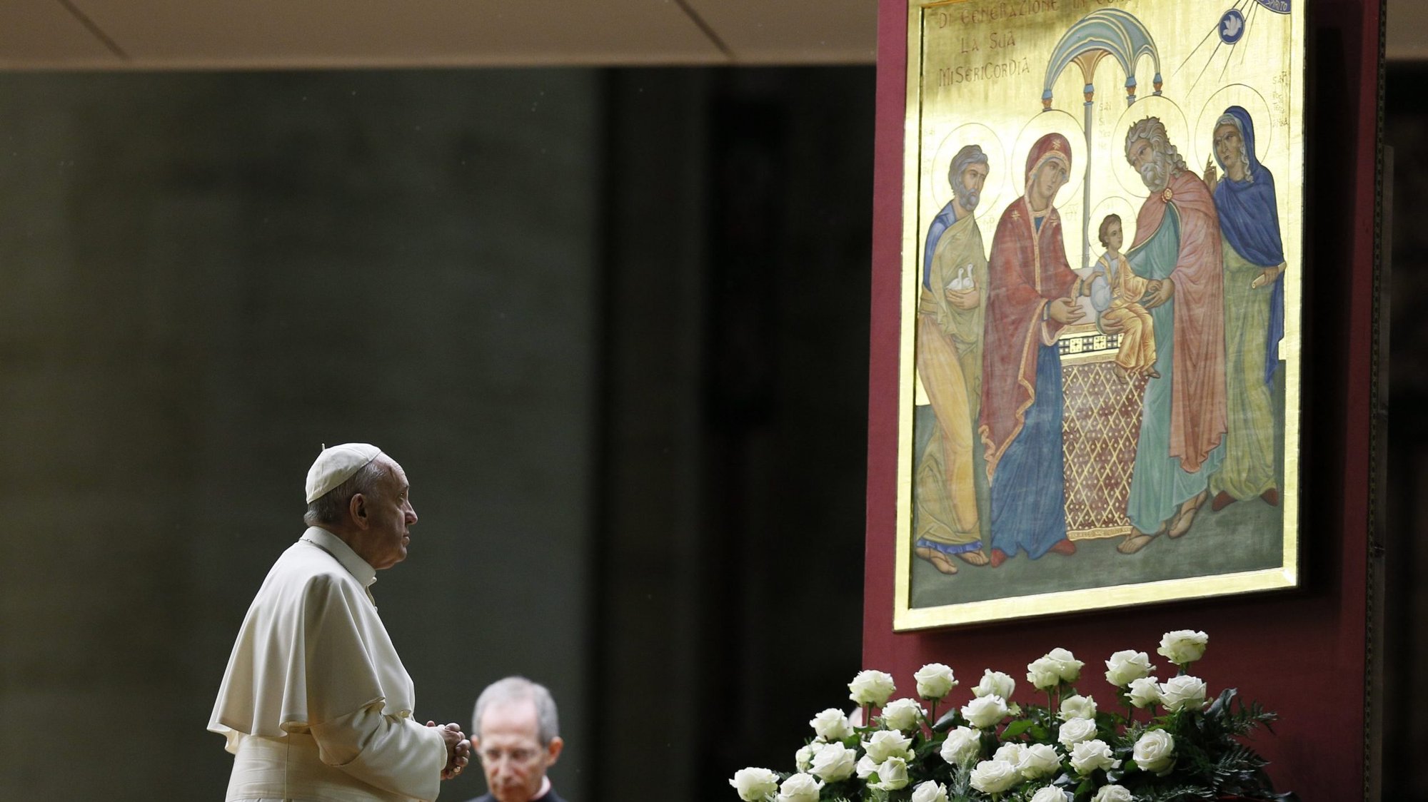 Pope Francis prays in front of an image of the Holy Family during a prayer vigil for the Synod of Bishops on the family in St. Peter's Basilica at the Vatican in 2015. (CNS/Paul Haring)