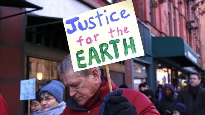 A man carries a sign during the annual Martin Luther King Jr. Day Interfaith Peace Walk Jan. 18 in the Upper West Side neighborhood of New York City. The theme of this year's event was "Hear the cry of the earth and the cry of the poor," from Pope Francis's encyclical "Laudato Si'." (CNS via Crux)