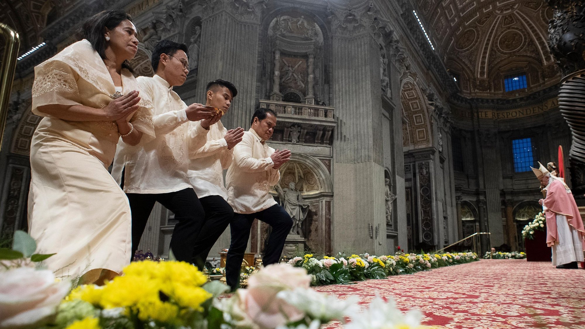 Members of the Filipino community in Rome approach the altar in the Vatican's St. Peter's Basilica during the offertory procession Dec. 15, 2019, as Pope Francis celebrates the first of the "Simbang Gabi," a novena of nighttime or pre-dawn Masses in preparation for Christmas. (CNS photo/Vatican Media)