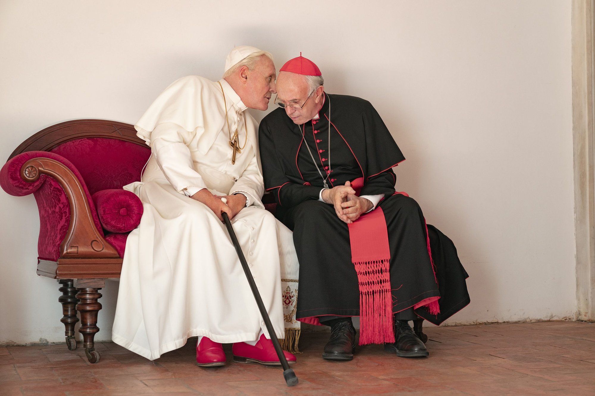 Anthony Hopkins portrays retired Pope Benedict XVI and Jonathan Pryce portrays the future Pope Francis in a scene from the movie "The Two Popes." (Peter Mountain, courtesy NETFLIX)