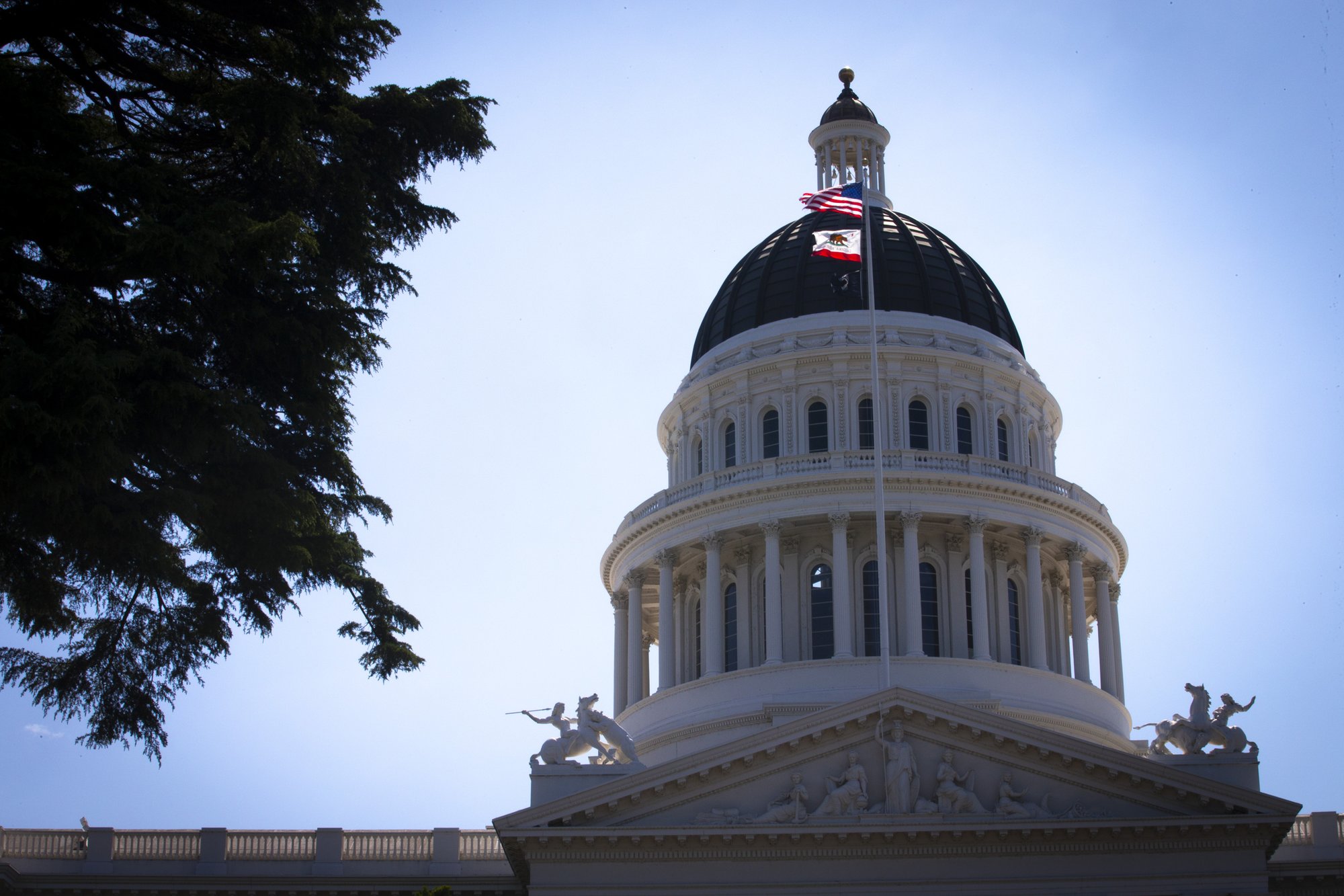 U.S. and California flags fly in front of the dome of the California Capitol in Sacramento May 9, 2019. (CNS photo/Chaz Muth)