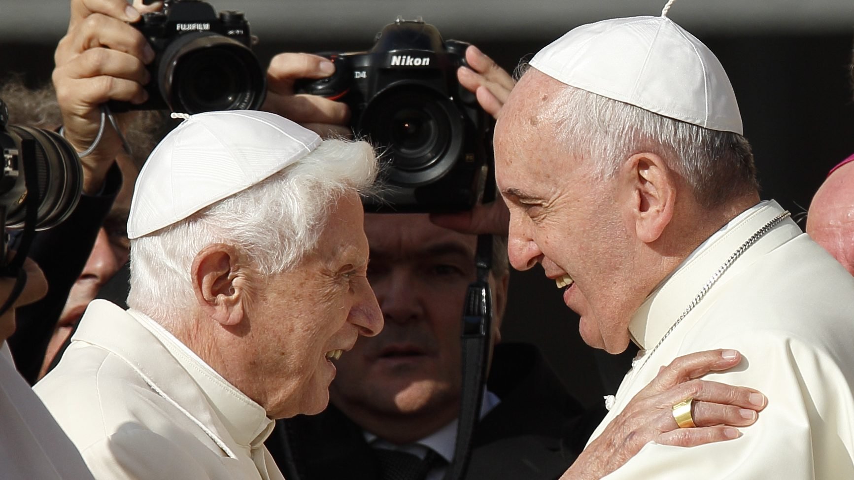 Pope Francis greets emeritus Pope Benedict XVI during an encounter for the elderly in St. Peter's Square at the Vatican in 2014. (Catholic News Service/Paul Haring)