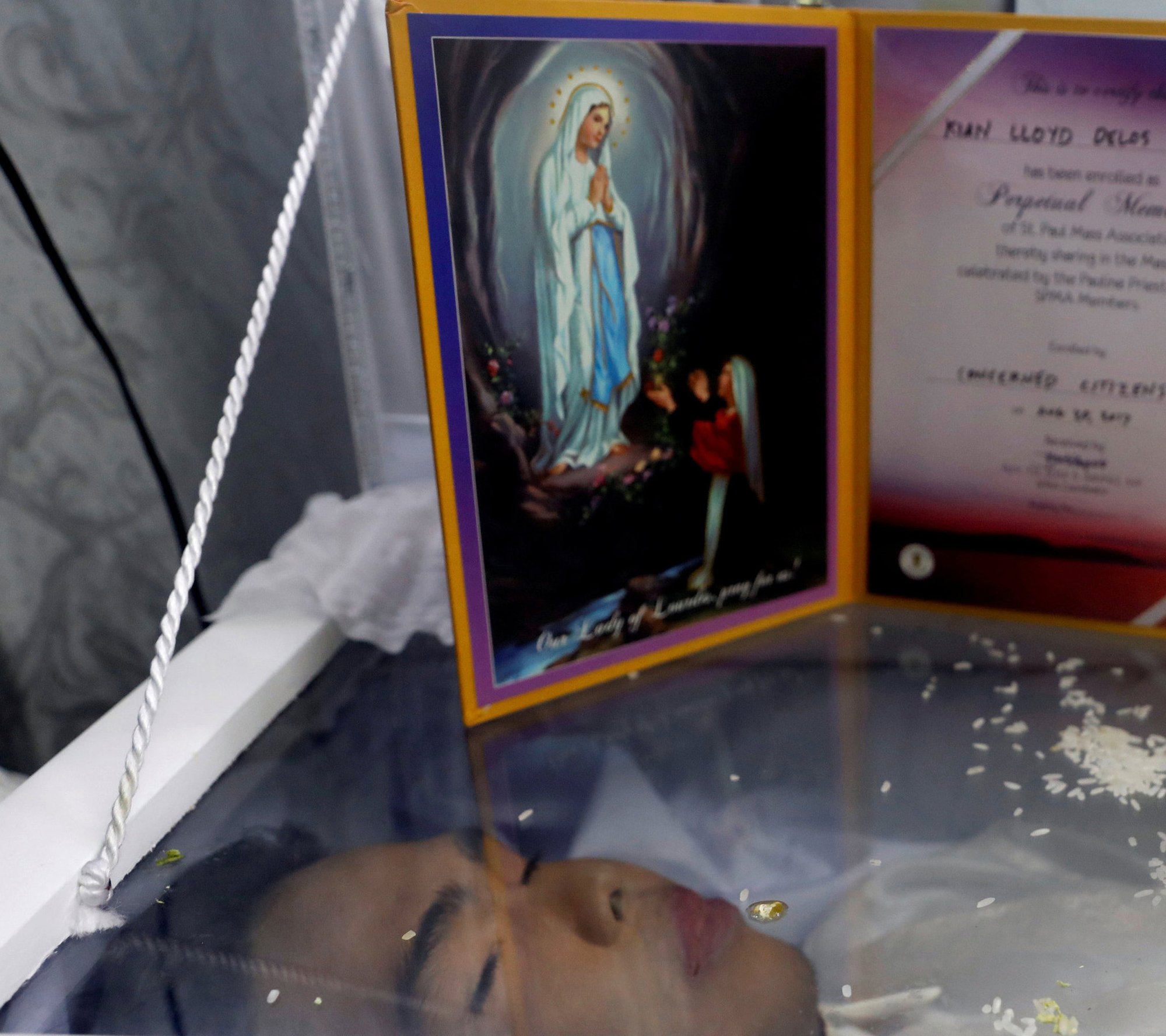 An image of Our Lady of Lourdes is seen in Manila, Philippines, on the coffin of Kian Delos Santos, 17, shot in an escalation of President Rodrigo Duterte's war on drugs. (CNS photo/Erik De Castro, Reuters)